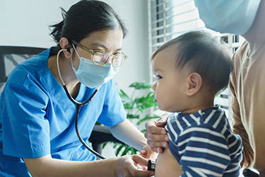 Doctor using a stethoscope on a baby